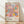 May include: Framed vintage exhibition poster featuring colorful abstract floral design with pastel pink, blue, orange and yellow blooms, polka dots and organic shapes. Text shows dates "28. APRIL - 14. MAI 1984" and "YAYOI KUSAMA" with "MUSÉE d'ART MODERNE DE LA VILLE DE PARIS" below. Light wood frame sits against white wall on blonde hardwood floor with natural window light creating soft shadows.