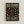 Framed museum exhibition poster with black background featuring scattered polka dots in muted tones of coral, sage green, cream, and gold. White text reads "YAYOI KUSAMA INFINITY DOTS FREVER" at top and "INFINITY DOTS FOREVER MUSEUM OF CONTEMPORARY ART 22 - APRIL 1986" at bottom. Light wood frame against white wall background.