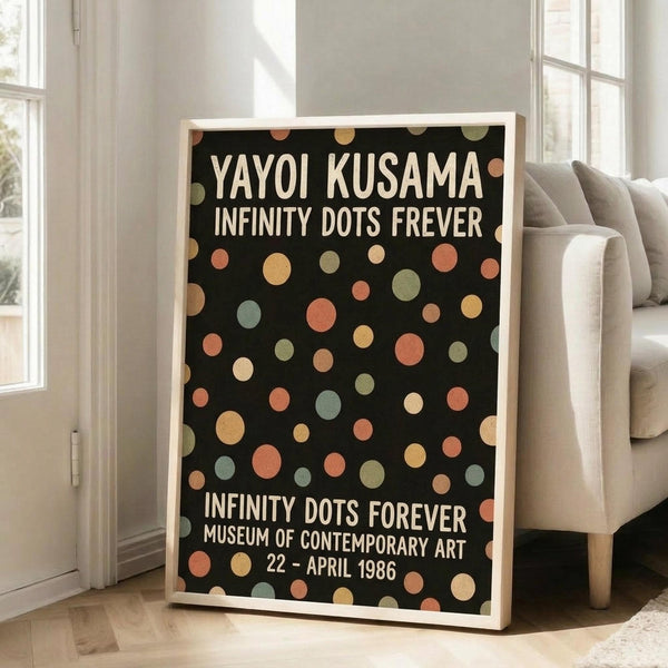 May include: Framed poster with black background and colorful polka dots in orange, yellow, green, and peach tones, displaying white text about a 1986 contemporary art museum exhibition, leaning against white wall next to beige upholstered sofa in bright living room with large windows and natural lighting on light wood floors.