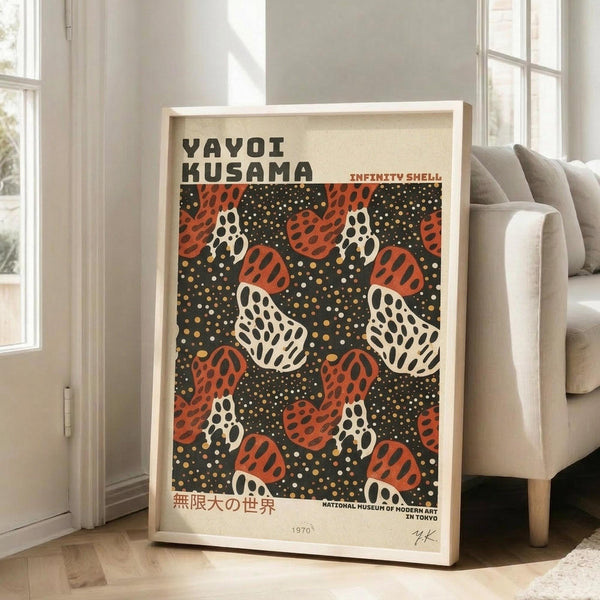 May include: Framed poster with orange and white polka-dotted shell shapes scattered across a dark spotted background, displayed in light wooden frame leaning against white wall next to beige upholstered chair in bright room with large windows