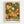 Framed art print featuring a vibrant pattern of overlapping circular floral motifs in orange, yellow, green, and white against a black background. The abstract design shows dotted sunburst patterns and stylized flowers in various sizes. Bold black text reads "YAYOI KUSAMA" with Japanese characters below and "NAGOYA" in the bottom right corner. The print is displayed in a light wood frame against a white wall.
