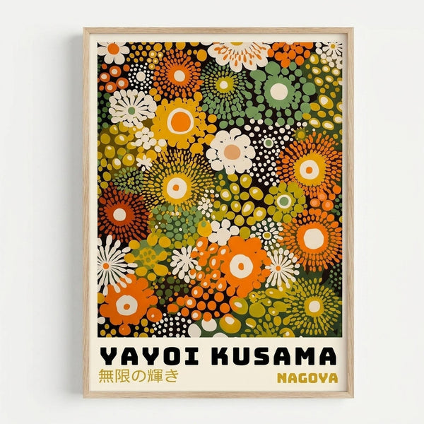 Framed art print featuring a vibrant pattern of overlapping circular floral motifs in orange, yellow, green, and white against a black background. The abstract design shows dotted sunburst patterns and stylized flowers in various sizes. Bold black text reads "YAYOI KUSAMA" with Japanese characters below and "NAGOYA" in the bottom right corner. The print is displayed in a light wood frame against a white wall.