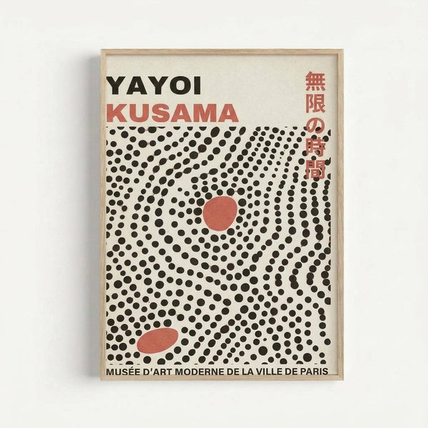 Framed exhibition poster with cream background featuring black polka dots in spiral pattern around central red circle, with "YAYOI KUSAMA" text at top in black and red letters, Japanese characters on right side, and "MUSEE D'ART MODERNE DE LA VILLE DE PARIS" at bottom. Light wood frame against white wall.