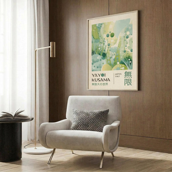 May include: Framed poster with abstract green and yellow botanical design featuring dots and organic shapes, displayed on wood paneled wall above beige upholstered armchair with geometric patterned pillow. Modern reading corner with brass floor lamp, dark round side table with open book, and white curtains. Warm natural lighting on wooden floors creates cozy contemporary interior setting.