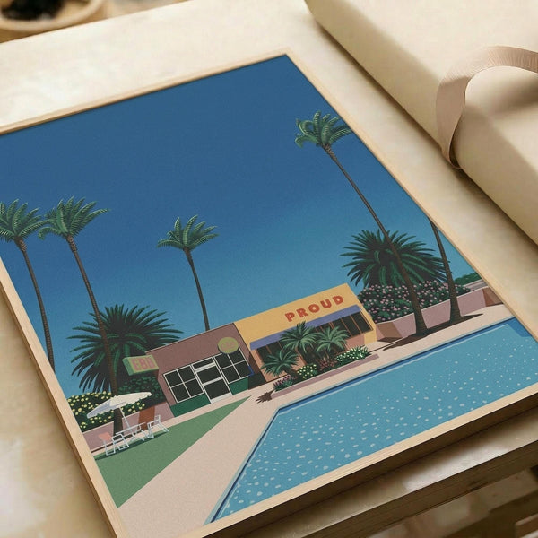 Flat art print featuring a retro-style illustration of a mid-century modern building with "PROUD" text on its facade, surrounded by tall palm trees against a bright blue sky. A turquoise swimming pool appears in the foreground with a concrete deck and landscaped areas with small flowering plants. The artwork uses a vintage color palette of blues, pinks, and greens in a minimalist, stylized aesthetic reminiscent of 1980s Japanese graphic design.