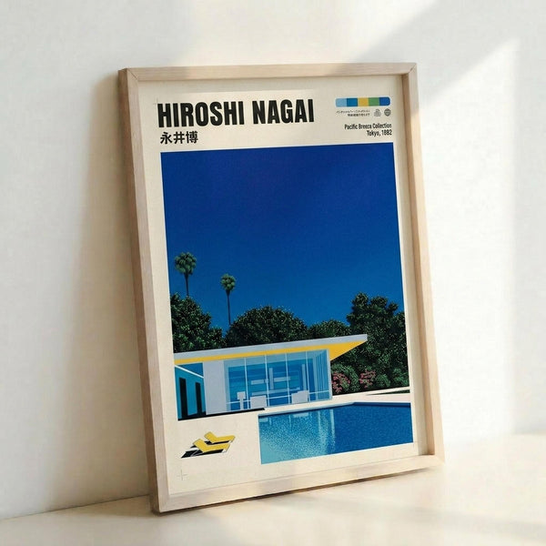 May include: Framed poster print leaning against white wall showing modernist poolside scene with glass house, bright blue swimming pool, palm trees, and deep blue sky. Light wood frame surrounds white-bordered print with "HIROSHI NAGAI" text at top. Clean minimalist aesthetic with vibrant blues, yellows, and greens depicting sunny California-style architecture and landscape.