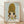 May include: Framed poster print featuring anime-style illustration of young girl with large golden blonde hair in ponytails, oversized dark eyes, and yellow top against pale blue background. Text reads "YOSHITOMO NARA" with Japanese characters and "1992年8月31日〜10月31日" below. Natural wood frame displayed on light wooden floor against white textured wall with diagonal shadows.