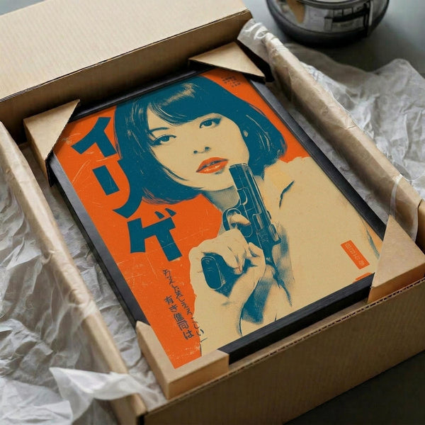 Vintage-style poster featuring a woman with blue bob haircut holding a revolver, rendered in retro orange and blue color scheme with Japanese text. The framed artwork is carefully packed in a cardboard box with protective tissue paper wrapping, shown during unboxing with wooden handles visible alongside.