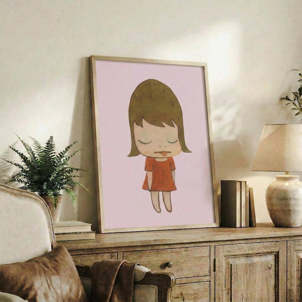 May include: Framed poster featuring minimalist illustration of young girl with brown bob haircut and closed eyes, wearing red dress on soft pink background, displayed on rustic wooden sideboard alongside fern plant, books, ceramic vases and brown leather chair in warm-toned living room setting