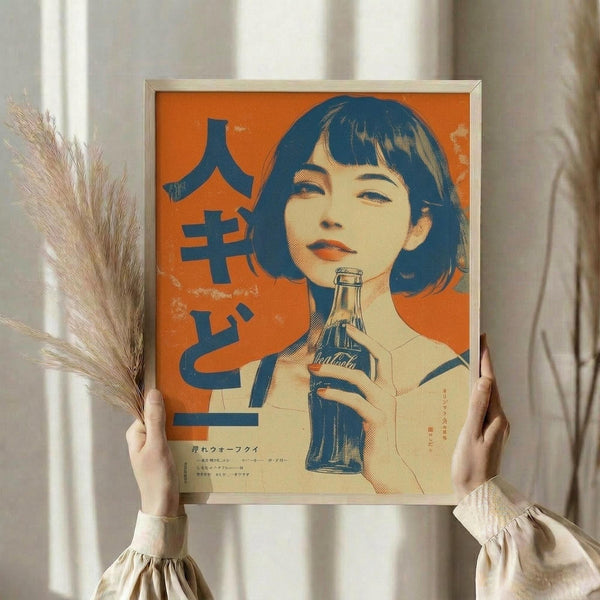 May include: Person holding framed vintage-style poster featuring Japanese woman with dark bob haircut holding Coca-Cola bottle against bright orange background with blue Japanese characters. Poster has light wood frame. Person wears cream ruffled sleeves and holds dried wheat stems, standing near white curtained window in soft natural lighting.