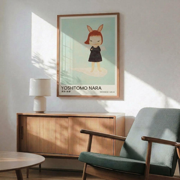 May include: Framed poster featuring a cartoon-style child character with red bob haircut and rabbit ears, wearing a dark dress on mint green background, displayed above a wooden sideboard with table lamp in a mid-century modern living room setting with teal upholstered chair and round coffee table
