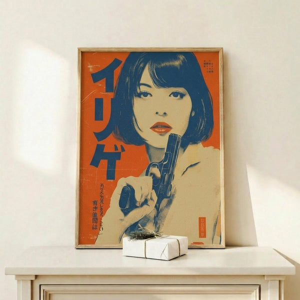 May include: Framed vintage-style poster with orange background featuring woman with blue bob haircut holding gun, displayed on light wood shelf next to small white gift box with greenery sprig against cream wall