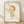 May include: Framed art print featuring a cute illustrated character with blonde bob haircut, green eyes, and light blue dress, displayed in light wood frame against white textured wall on wooden floor with soft natural lighting casting shadows.