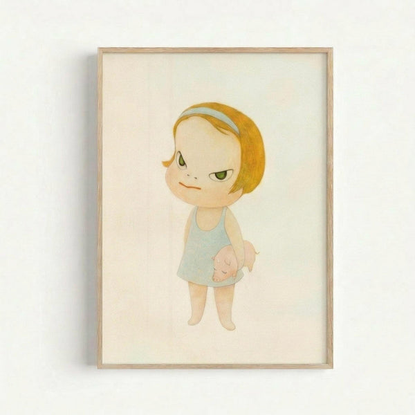 Framed artwork showing a stylized illustration of a young child with short blonde hair and green eyes, wearing a light blue dress or top. The child has a subtle, knowing expression and appears to be holding or wearing something with a small pig motif. The illustration is rendered in soft, muted colors with a minimalist style against a cream background, displayed in a simple light wood frame mounted on a white wall.