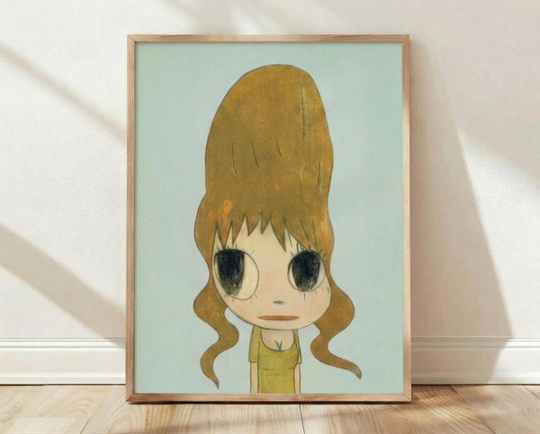 May include: Framed art print displayed on wooden floor against white wall with natural light shadows. Shows cartoon-style character with oversized golden blonde beehive hairstyle, large dark eyes, and yellow top against soft mint green background. Artwork has retro aesthetic with muted color palette in light wood frame.