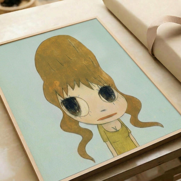 May include: Framed art print featuring anime-style illustration of young girl with long wavy blonde hair and large dark eyes, wearing yellow top against soft mint green background. Print sits on white bedding next to cream ribbon, showing warm natural lighting and delicate artistic style with soft color palette.