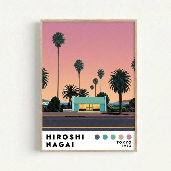 Framed poster featuring a mid-century modern turquoise house with palm trees silhouetted against a pink and orange sunset sky. The minimalist artwork shows a road in the foreground and coastal landscape in the background. Text reads "HIROSHI NAGAI" with "TOKYO 1973" and a color palette of circles in coordinating hues. The print is displayed in a light wood frame against a white wall.