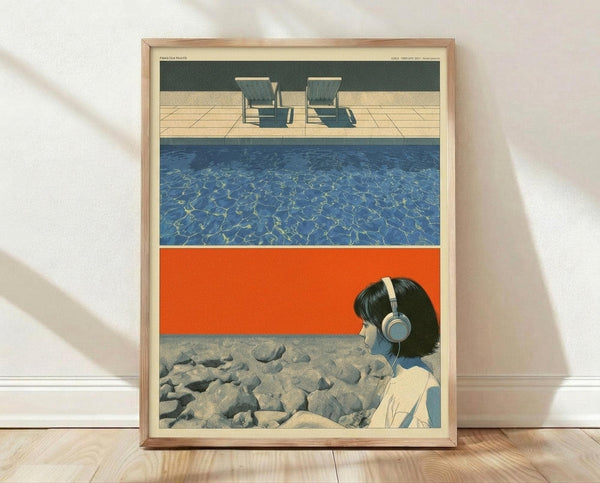 May include: Framed poster print leaning against white wall on light wood floor. Artwork shows three horizontal scenes - top has two lounge chairs by pool with teal water, middle shows blue swimming pool with light reflections, bottom depicts person with headphones sitting on rocky shore against orange sky background. Natural wood frame with cream matting.