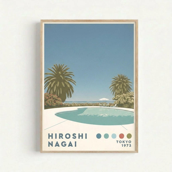May include: Framed poster print hanging on white wall showing tropical poolside scene with turquoise swimming pool, palm trees, blue sky, and small island in distance. Light wood frame surrounds artwork featuring muted blue, green, coral and cream color palette. Text reads "HIROSHI NAGAI" and "TOKYO 1973" with colored dots accent. Clean minimalist styling in contemporary interior setting.