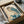 May include: Framed Japanese woodblock print of an owl with teal and blue feathers perched on flowering branches, displayed in black frame inside cardboard shipping box with protective wrapping and wooden dowels, showing vintage ukiyo-e art style with red artist seal