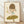 May include: Framed art print showing a cute cartoon child with brown bob haircut and green eyes, wearing light blue top, standing on large green mushroom while holding drumsticks with arms raised. Minimalist illustration in soft earth tones on cream background, displayed in thin wooden frame against white textured wall on light wood floor.