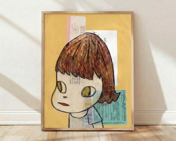 May include: Framed artwork featuring a cartoon-style illustration of a pale child with brown bowl-cut hair and large yellow-green eyes on yellow background. Mixed media piece incorporates vintage documents and forms as collage elements. Natural wood frame sits on light wooden floor against white wall with soft shadows.