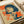 May include: Vintage-style Japanese poster print featuring a woman with short dark hair smoking a cigarette, rendered in blue and orange pop art style with Japanese text. The print is shown laying flat on white paper with a white tube or roll visible in the corner, displaying the retro graphic design with halftone dot patterns and bold typography.