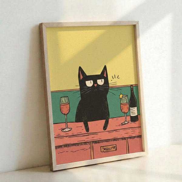 May include: Framed poster print leaning against white wall showing cartoon black cat sitting on wooden bar counter with wine glasses and bottle. Cat has droopy eyes and whiskers with yellow background, teal green backsplash, and coral pink wooden counter. Light wood frame casts shadow on wall.