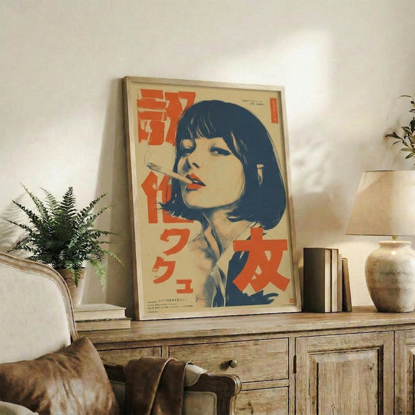 May include: Framed vintage-style poster featuring a woman with dark blue bob haircut smoking a cigarette, rendered in retro illustration style with orange and red Japanese text on cream background. Display shows rustic wooden sideboard with fern plant, stacked books, ceramic vase, and brown leather chair in modern living room setting with white walls and warm lighting.