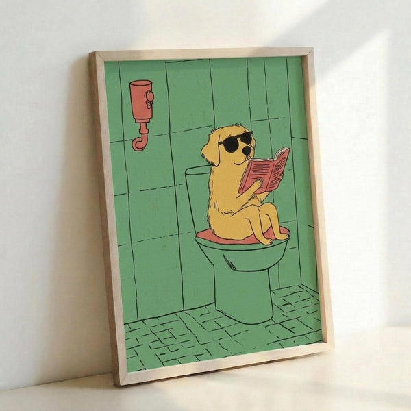 May include: Framed cartoon illustration of a golden retriever wearing sunglasses sitting on a toilet while reading a red book. The bathroom scene features green tile walls, a plunger, and green floor tiles. The artwork is displayed in a light wood frame leaning against a white wall, showing the humorous poster print in a simple indoor setting.