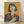May include: Framed vintage-style Japanese Coca-Cola advertisement poster with yellow-orange background featuring woman with black bob haircut holding classic Coke bottle, displayed against white wall on wooden floor. Red Japanese characters overlay the blue-toned illustration in retro pop art style with weathered texture effects.