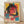 May include: Framed poster print leaning against white wall on light wooden floor. Artwork features woman with round glasses and headphones in vibrant cyberpunk style with hot pink, yellow, teal, and orange colors. Japanese text overlays geometric digital elements. Natural wood frame surrounds cream-colored paper with speckled texture. Soft natural lighting creates diagonal shadows across white textured wall background.