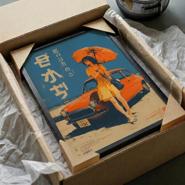 May include: Framed vintage-style Japanese poster with blue background featuring woman in orange dress holding umbrella next to classic orange car, displayed in black frame inside cardboard shipping box with protective wrapping materials on white surface