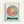 Framed poster print featuring the red-haired protagonist Ponyo from Studio Ghibli's animated film. The character is shown in a circular blue bubble surrounded by smaller fish-like creatures, all rendered in the distinctive Studio Ghibli art style with warm coral and teal colors. The movie title "PONYO" appears in large brown letters below the circular illustration, with "A STUDIO GHIBLI FILM" text at the top. The print has a light wooden frame and sits against a white wall.