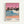 Framed poster artwork showing a tropical beach scene with pink sunset sky, blue ocean waves with white foam, palm trees silhouetted on dark cliffs, two small figures on peachy sand beach, and artist name with colored dots at bottom in light wood frame against white wall