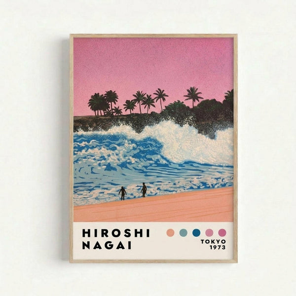 Framed poster artwork showing a tropical beach scene with pink sunset sky, blue ocean waves with white foam, palm trees silhouetted on dark cliffs, two small figures on peachy sand beach, and artist name with colored dots at bottom in light wood frame against white wall