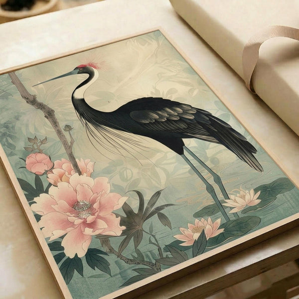 May include: Japanese-style art print featuring an elegant black crane with white chest and red crown detail, surrounded by large pink peonies and green foliage on a soft sage background. The print is displayed on cream paper with natural lighting, showing fine details and muted watercolor tones in a traditional botanical illustration style.