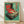 May include: Framed vintage-style poster featuring a retro turntable with red vinyl record and open lid, illustrated in green, red, and cream colors with Japanese text. Wooden frame leans against white wall on light wood flooring with soft shadows from natural lighting.