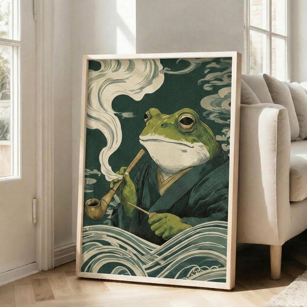 May include: Framed artwork displaying a green frog character in traditional Japanese ukiyo-e woodblock print style, wearing dark robes and smoking a pipe with white smoke curls, surrounded by stylized waves and clouds in teal and cream colors. The medium-sized print leans against a beige armchair in a bright living room with white walls and large windows.