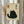 May include: Framed poster featuring a black cat illustration with Japanese calligraphy characters on beige textured background, displayed on white wall next to dried pampas grass stems in neutral home setting