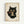 Framed artwork showing a black kitten with large golden eyes using chopsticks to eat noodles from a dark bowl. The illustration is done in traditional Japanese ukiyo-e woodblock print style on aged, cream-colored paper with visible texture and staining. Red Japanese characters and seals appear in the bottom corners. The piece is displayed in a simple light wood frame against a white wall.