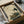 May include: Traditional Japanese artwork print featuring a white stork with dark wing tips standing on one leg above a detailed turtle with hexagonal shell patterns, surrounded by green foliage on aged beige paper background with calligraphy text, displayed in black frame being unboxed from cardboard packaging with tissue paper wrapping