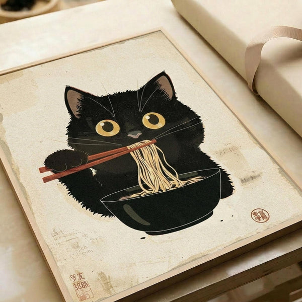 Framed print showing a black cat with golden eyes eating ramen noodles with chopsticks from a dark bowl. The artwork features traditional Japanese woodblock print style with beige background and red artist seal stamps. The print appears aged with subtle staining and is displayed in a light wooden frame alongside rolled white papers on a cream surface.