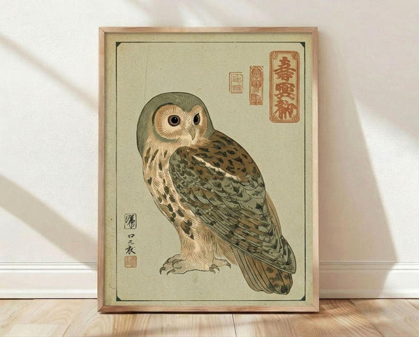 May include: Framed vintage-style Japanese woodblock print of a brown and tan owl with large dark eyes, featuring traditional calligraphy characters in red seals, displayed against white walls on light wooden floors in natural lighting