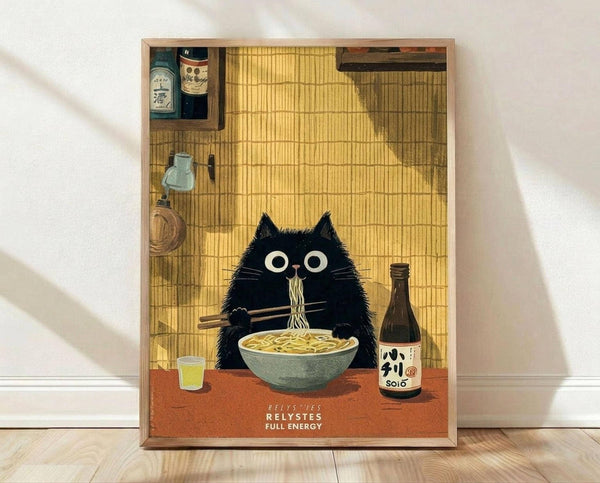 May include: Framed art print leaning against white wall on light wood floor. Shows black cat with large white eyes eating ramen noodles with chopsticks at orange table. Japanese-style setting with bamboo mat background, sake bottle, small glass, shelving with bottles. Warm yellow lighting, cartoon illustration style in thin wooden frame.