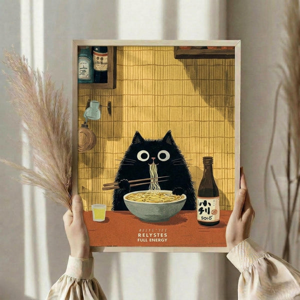 May include: Person holding framed poster print showing black fluffy cat with large white eyes eating ramen noodles with chopsticks at orange table, Japanese-style interior with bamboo mat background, sake bottles and shelves visible, warm golden lighting, cream colored frame, person wearing beige ruffled sleeves, dried pampas grass visible to left