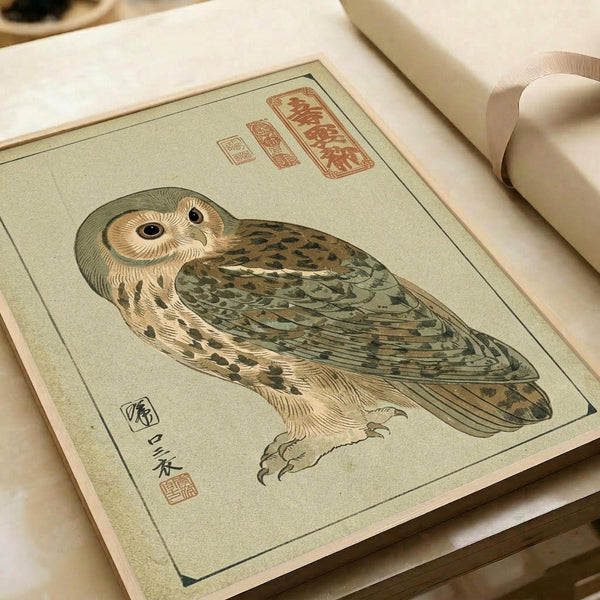 A traditional Japanese woodblock print of an owl rendered in muted greens, browns, and cream tones on aged paper. The detailed illustration shows the owl's intricate feather patterns and large round eyes, with red Japanese calligraphy seals in the upper corners and black characters along the left side. The print appears in an open book or portfolio with white pages visible in the background.