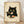 May include: Framed poster print leaning against white wall on light wooden floor. Artwork shows adorable black cat with large yellow eyes holding chopsticks with sushi piece, sitting behind plate of assorted sushi rolls. Japanese-inspired vintage style illustration on cream background with Asian characters in corners. Natural wood frame, soft lighting creates gentle shadows on textured white wall.