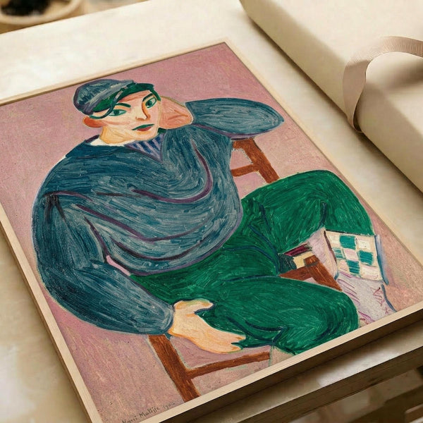 A colorful Fauve-style painting showing a seated figure in a dark blue sweater and green cap, positioned in a wooden chair against a pink background. The person holds what appears to be a small artwork or card. Bold, expressive brushstrokes create flowing forms in blues and greens. The artwork is displayed flat on white paper in what appears to be an art book or portfolio.