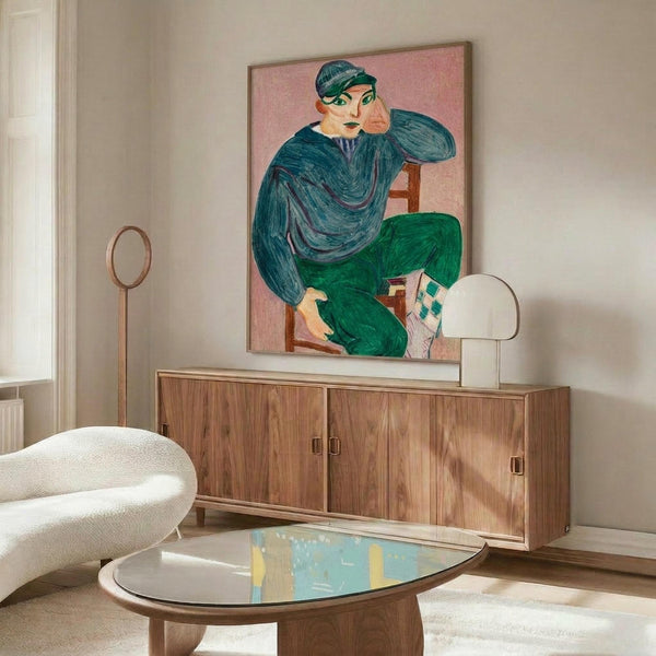 May include: Colorful portrait painting of seated figure in blue top and green pants on pink background, displayed above wooden credenza in modern living room with white curved chair, glass coffee table, and floor lamp